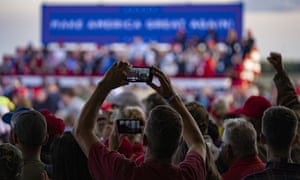 A supporter takes a picture at Trump’s campaign rally.
