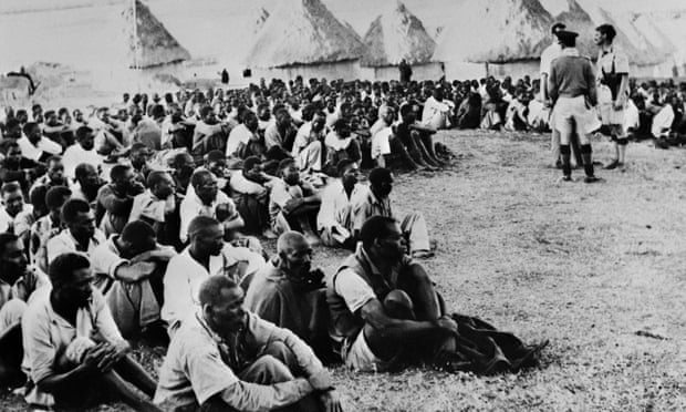 Hundreds of arrested Kenyans wait to be questioned in a Mau Mau camp, in March 1953