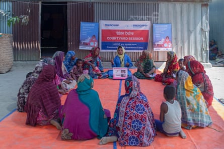 Women sit in a circle during a health awareness session about cervical cancer in Kamarbashpata, Bangladesh. 