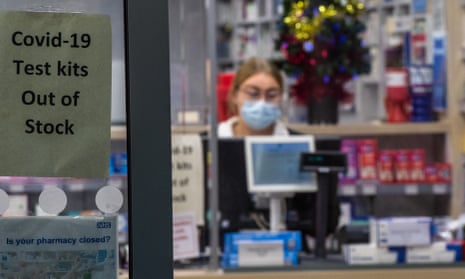 A sign in the window of a pharmacy informs customers that Covid-19 lateral flow test kits are out of stock in Ashford, England.