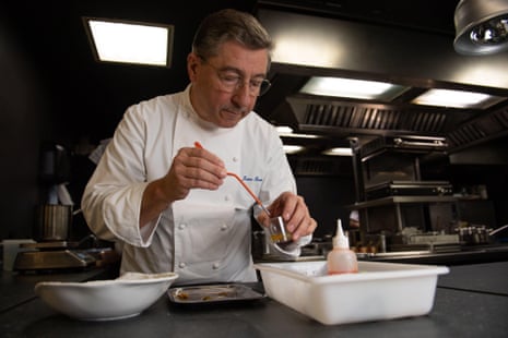 A male chef prepares food in a restaurant kitchen