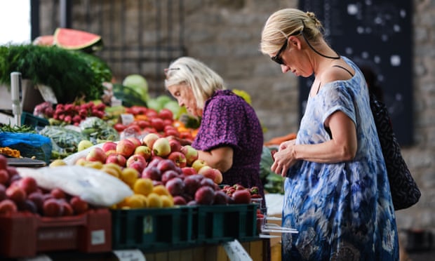 women look at their wallets to dig out change