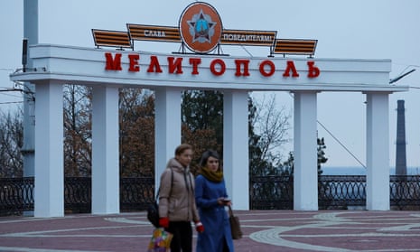 Women walk through a square in Melitopol