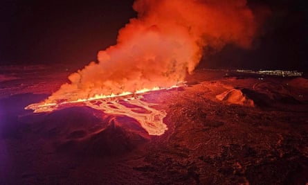 Bright orange fire and lava spew from the ground