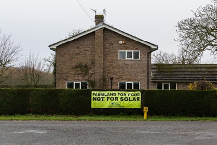 An anti-solar farms sign on a hedge outside a house in Lincolnshire, UK