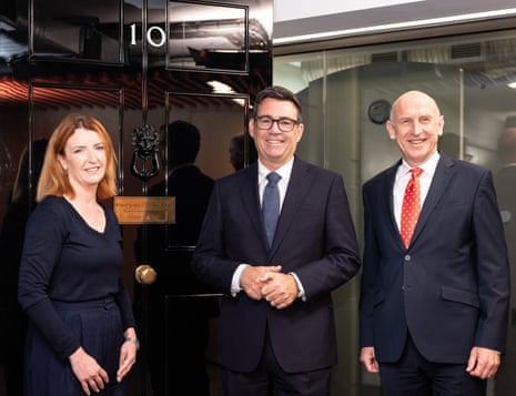 Prime Minister Andy Burnham, with Minister for the Cabinet Office Louise Haigh on his left and Chancellor of the Exchequer John Healey on his right, standing by the door to No 10 North.