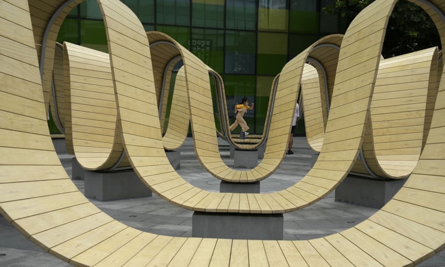 A child wearing a mask runs through an art installation at a mall in Beijing.