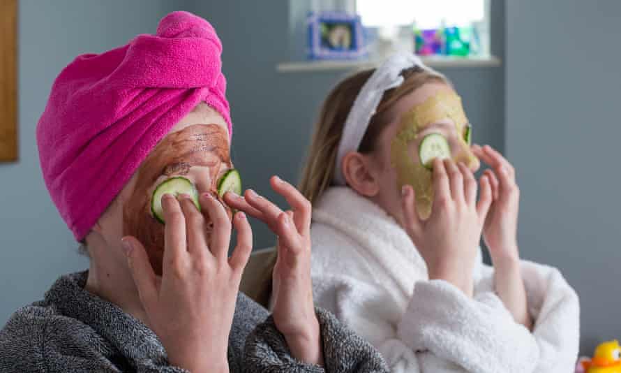 young girls with facemasks and cucumber on eyes