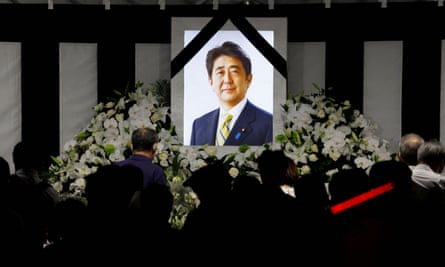 People lay flowers and pay their respects outside Nippon Budokan Hall where the state funeral for former Prime Minister Shinzo Abe was held, in Tokyo.