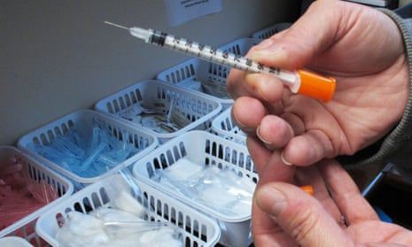 A nurse holds a needle used in a needle exchange program. 