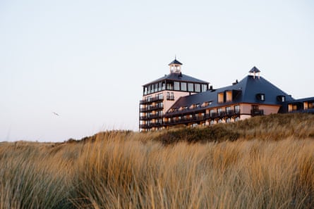 A hotel sits on a sand dune overlooking the Zeeland coast.