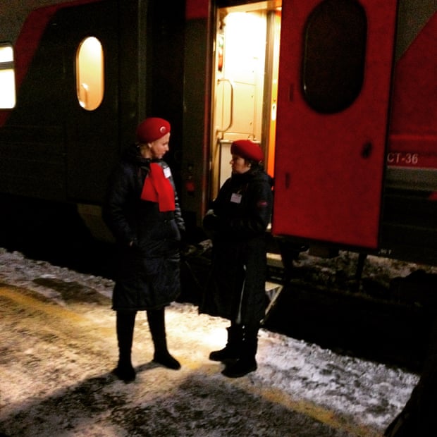 Two provodnitsa (carriage attendants) confer.