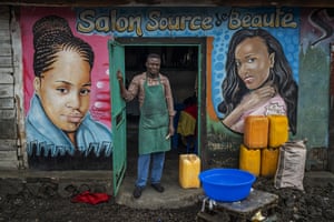 Mohimbo, 48, poses in front of his hairdressing salon in Goma, Democratic Republic of Congo