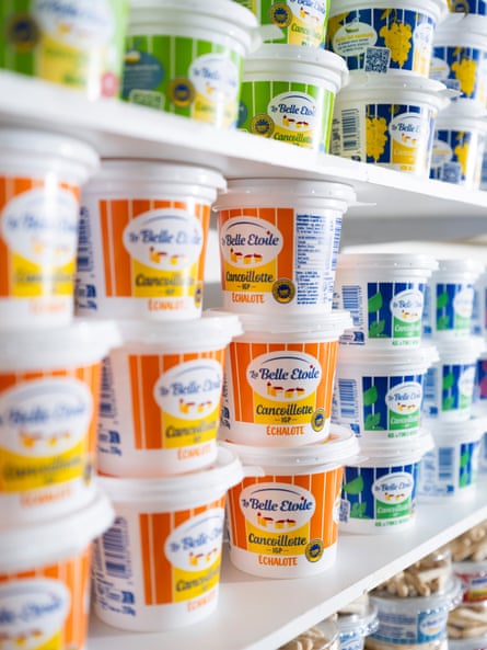 Cancoillotte cheese in different coloured pots on a shelf