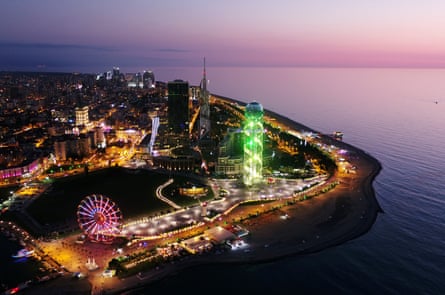 Batumi after dark, with neon lights and ferris wheel