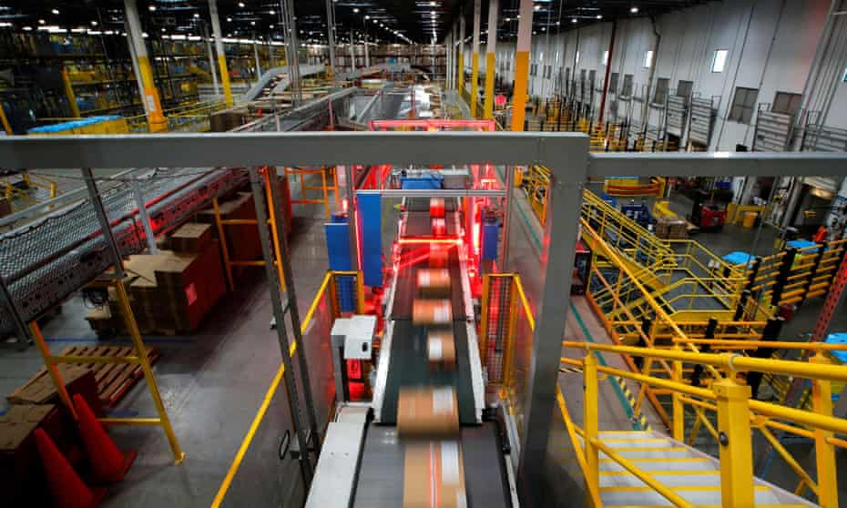 A fast-moving conveyor moves packages through a scanning machine on their way to delivery trucks at Amazon's fulfillment center in Robbinsville, New Jersey.