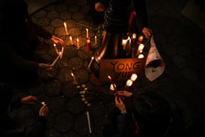 Mourners light candles around a sign remembering Yong Yue, one of the victims of the March 2021 Atlanta spa shootings, during the Vigil for Victims of Asian Hate in Union Square, New York City, on 19 March 2021