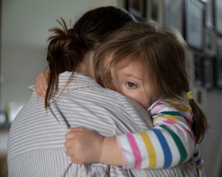 toddler cuddling her mother