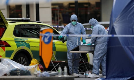 Forensic officers work at the scene of the attack on London Bridge.