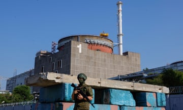 A Russian service member stands guard at a checkpoint near the Zaporizhzhia nuclear plant in 2023
