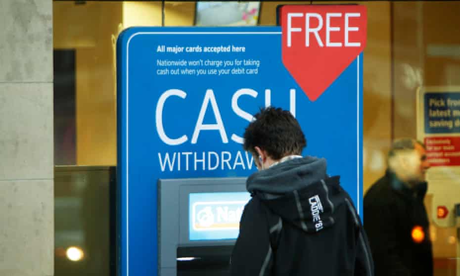 Young man at cashpoint