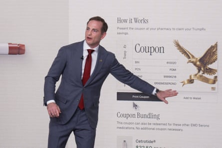 A man speaks in front of a display for a website
