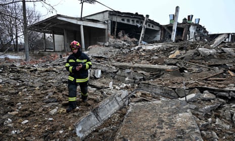 A rescuer walks amid rubbles of a destroyed building following Russian strikes in Kharkiv, eastern Ukraine.
