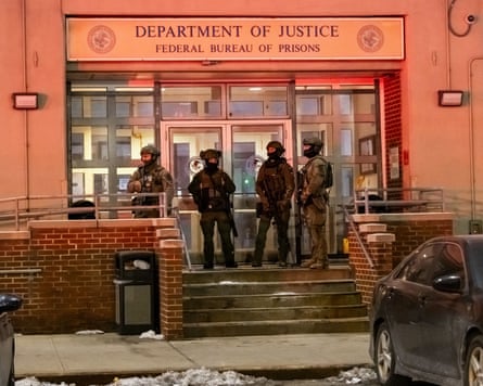 Metropolitan Detention Center in Brooklyn, New York with armed men in front guarding it