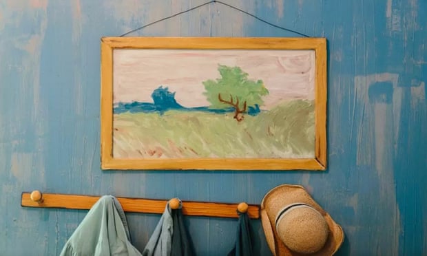 A picture of a tree in a field hangs above a coat rack in the Art Institute of Chicago's 3D replica of Van Gogh's Bedroom in Arles