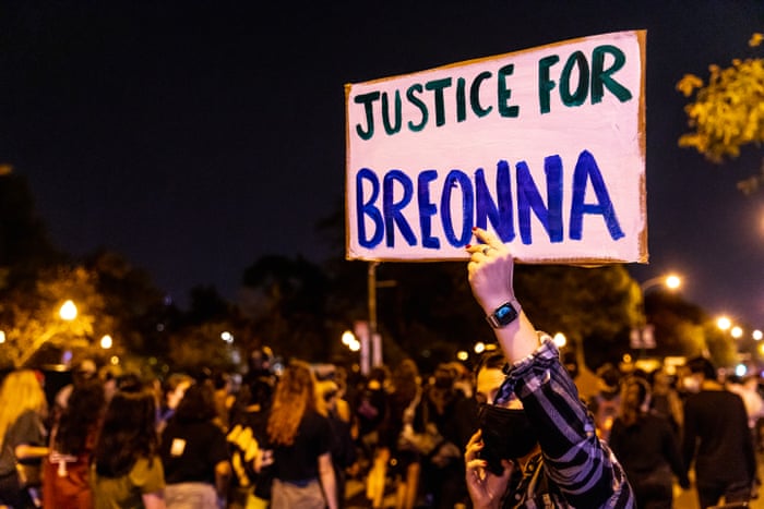A protester carries a sign in honor of Breonna Taylor in Chicago, Illinois.