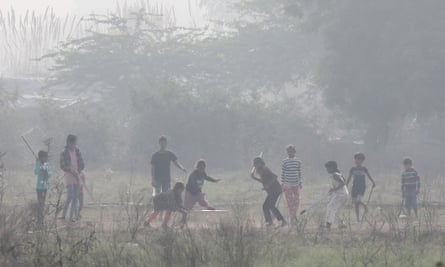 Children playing in a park amid smog.