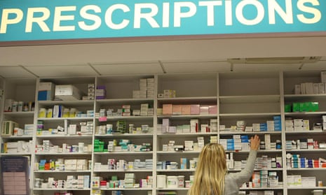 A pharmacist stocking shelves at a chemist. 
