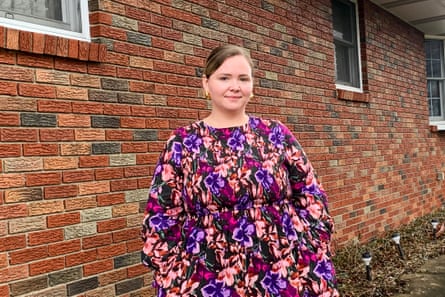 A woman stands outside a residential building