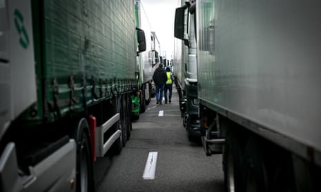 Farmers walk among trucks blocking the A7 motorway near Arbon in southeastern France.