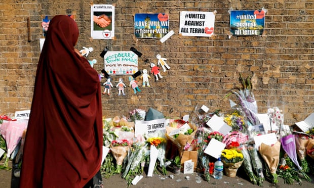 People stopping to read tributes and look at plawers placed in the Finsbury Park area of north London on June 20, 2017, for the victims of a alleged van attack on pedestrians nearby on June 19. 