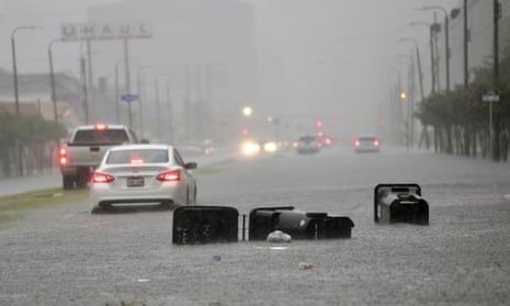 Vehicles head down a flooded Tulane Avenue as heavy rain falls on Wednesday in New Orleans.