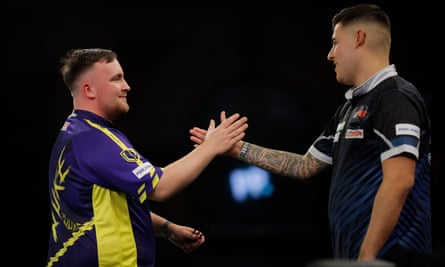 Luke Littler (left) shakes hands after winning his 2nd round match against Ryan Meikle