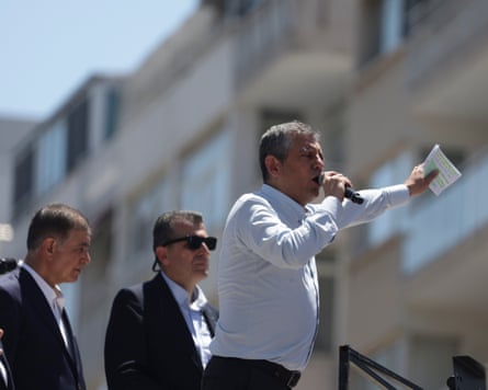 Özgür Özel with a microphone addressing a crowd