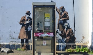 Banksy’s mural depicting agents monitoring a phone box near GCHQ in Cheltenham.