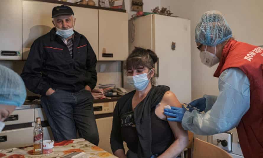 A woman receives a dose of the Chinese Sinopharm Covid-19 vaccine in the village of Leskovik near the city of Nis, Serbia.