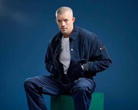 Studio portrait of Russell Tovey with his hands in his jacket pockets