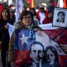 people march sadly with images from the pinochet regime