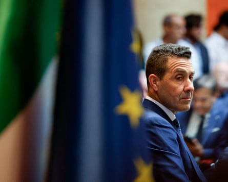 Vannacci with flags beside.