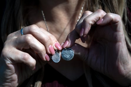 Karen Sutherland holds a necklace with her son Shayne’s fingerprint and name at Park View Cemetery in Manteca, California, on 25 February 2024.