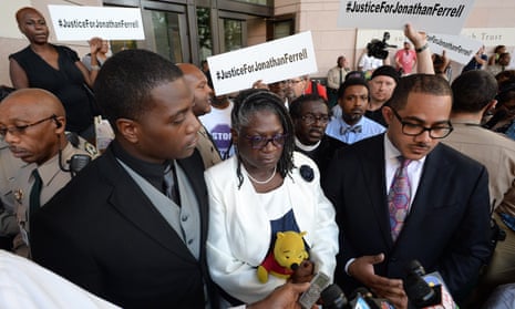 Jonathan Ferrell’s brother Willie Ferrell, left, and his mother, Georgia Ferrell, answers reporters questions alongside family attorney Chris Chestnut, right, after a mistrial was declared yesterday.