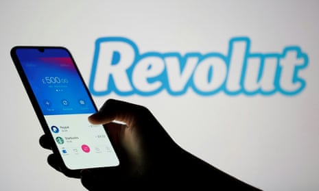 Woman holds smartphone with Revolut app