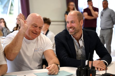 Prince William smiling at a gesturing Ross Kemp