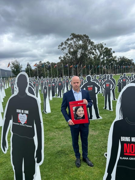 Elad Levy with the cardboard cutouts representing the people who were taken hostage or killed by Hamas on 7 October.