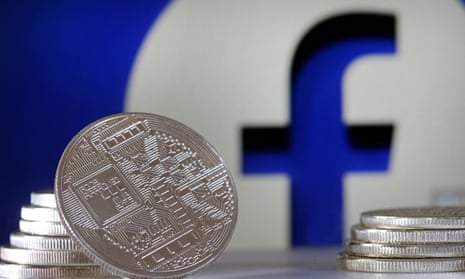 New cryptocurrency Libra coins with the Facebook logo in the background.