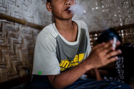 A boy smokes a cigarette in Yogyakarta, Indonesia.